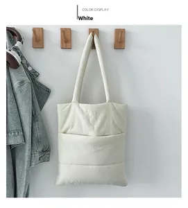 Quilted padded tote bag in cream white hanging on a wooden hook for lifestyle display