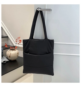 Quilted down cotton tote bag hanging on a door handle in a modern home interior