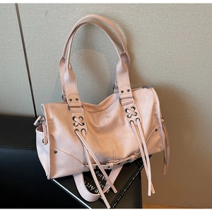 Detail of soft pink PU leather tote bag with lace-up design and metal eyelets on base