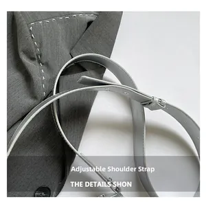 Close-up of adjustable grey leather shoulder strap with precise stitching on camera bag
