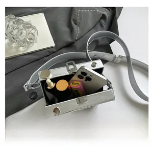 Interior view of the silver hard-shell camera bag showing phone and cosmetics capacity