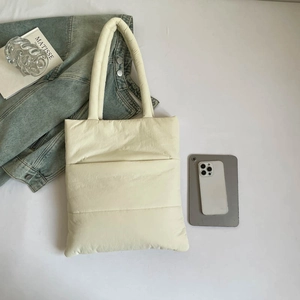 Minimalist cream quilted tote bag for women showing a spacious interior for travel and work