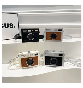 Detailed view of creative camera-shaped crossbody bags in four stylish color options