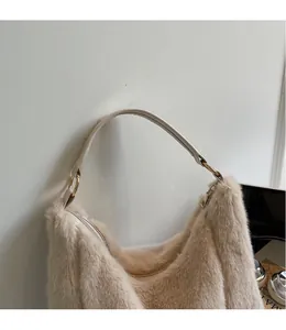 Detail of soft apricot plush tote with slim leather handles and gold ring hardware