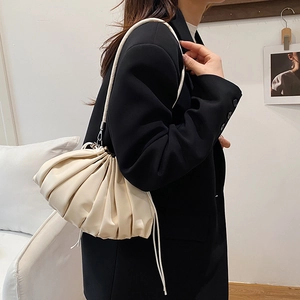 Minimalist creamy white dumpling shoulder bag featuring pleated drawstring design for women