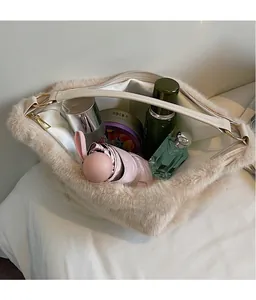 Interior view showing the large storage capacity of the beige plush tote bag with gold hardware