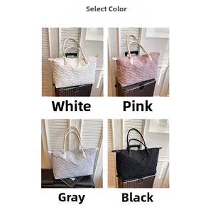 Quilted travel tote bag collection in white, pink, grey, and black nylon colors