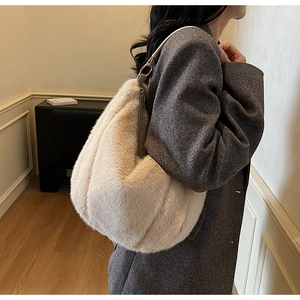 Detail of plush off-white faux fur tote with striped texture and adjustable shoulder strap