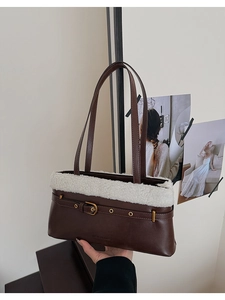 Close-up of brown PU leather shoulder bag with white faux fur trim and metal buckle detail