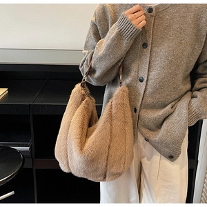 Close-up of plush hobo tote bag featuring brown leather strap and metal ring detail