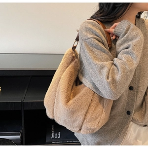 Detail of plush faux fur shoulder bag with leather strap shown in a lifestyle setting