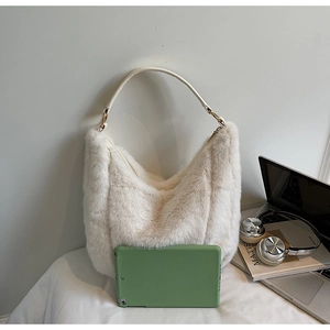 Detailed comparison of plush hobo tote bag size with a tablet and lifestyle items