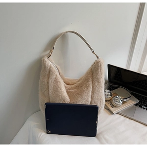 Spacious beige faux fur tote bag showing size scale next to a tablet and lifestyle props