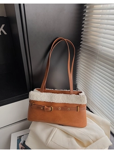 Detail of brown PU leather and white plush fleece patchwork shoulder bag with buckle