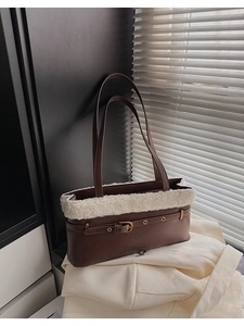 Detail of retro brown PU leather shoulder bag with white plush faux fur trim and buckle strap