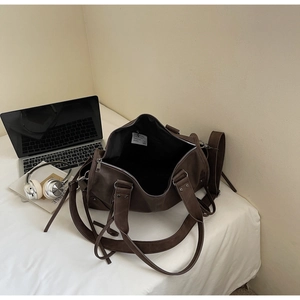 Détail du grand sac cabas en similicuir marron avec poignées robustes et fermetures éclair
