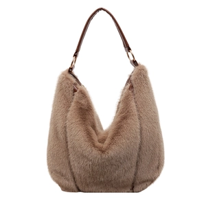 Brown faux fur hobo tote bag with dark leather handle and gold metal rings