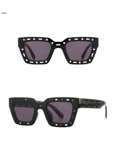 Detail of square oversized sunglasses with unique cutout temples and black grey lenses