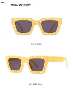 Detail of yellow hollowed geometric frame sunglasses with dark gray lenses
