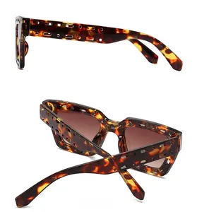 Detail view of square tortoiseshell sunglasses with side and back cutout frame design