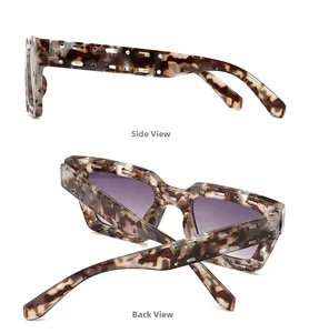 Detail of square sunglasses with hollowed frames and purple gradient lenses in amber