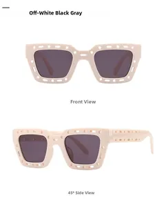 Detail of square off-white sunglasses with hollow-out frames and dark gray lenses