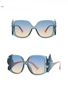 Detail of square oversized blue cat-eye sunglasses with gradient tea lenses from two angles