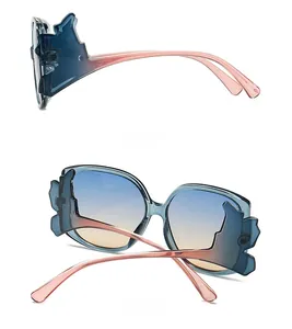 Detail view of the batwing butterfly frame sunglasses with blue to pink gradient finish