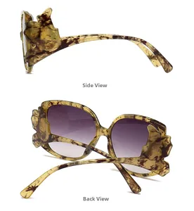 Detail of tortoise frame sunglasses with purple gradient lenses and flame shaped temples