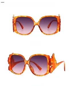 Detail view of leopard print frames with purple gradient lenses and zigzag temples