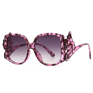 Modern square cat-eye sunglasses with purple tortoiseshell frame and gradient lenses