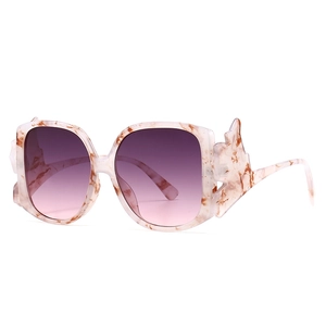 Modern oversized cat-eye sunglasses with marble pink frame and purple gradient lenses