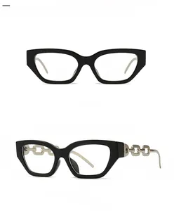 Detail of cat-eye black frames with silver metal chain temples and transparent lenses