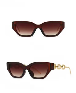 Detail view of square sunglasses with dark tea frames and gold metal chain temples