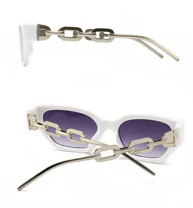 Detail of white rectangle sunglasses with purple gradient lenses and gold chain temples