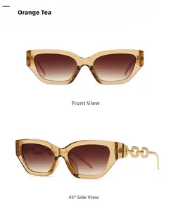 Detail view of narrow amber sunglasses with brown lenses and golden metal chain temple
