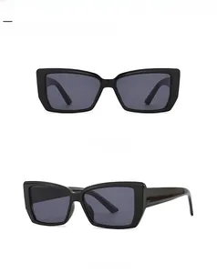 Front and side view of modern butterfly sunglasses with thick black frames and gray lenses