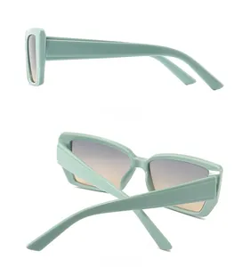 Detail view of mint green retro butterfly sunglasses with gradient lenses and thick temples