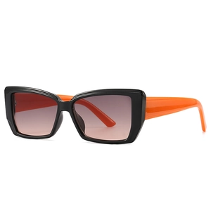 Modern butterfly sunglasses with black frames and vibrant orange temples in a 45-degree view