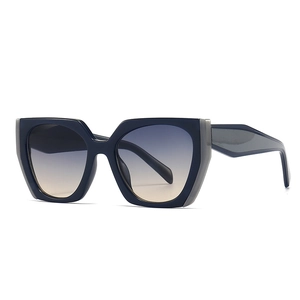 Cat eye oversized sunglasses with deep blue frames and grey gradient lenses in a modern style