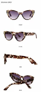 Détail de lunettes de soleil papillon en écaille avec verres dégradés violets et décor doré