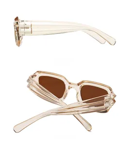 Detail view of champagne square sunglasses with wide textured temples and brown lenses