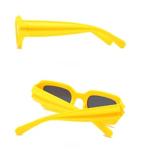 Detail view of yellow sunglasses showing side profile and ribbed temple design