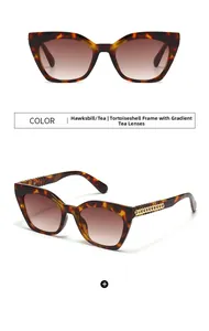 Détail de lunettes de soleil écaille avec verres dégradés marron et branches chaîne dorée