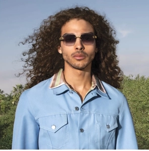 Detail of square gradient lenses and gold metal hardware on flat top sunglasses