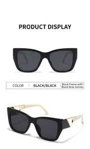 Detail of square cat-eye sunglasses featuring cream temples and gold hollow triangle decor