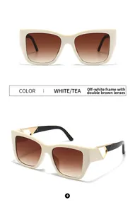 Close-up of square cat-eye sunglasses in cream with golden triangle hinge details
