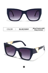 Detail of blue cat-eye sunglasses with gold triangle hollow decoration and gradient lenses