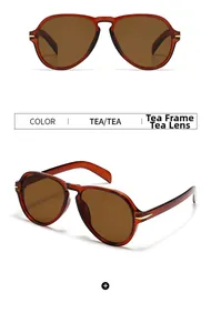 Detail view of aviator sunglasses with tea resin frames and gold metal arrow hardware