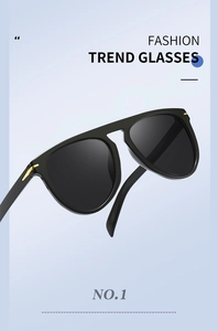 Macro detail of large frame sunglasses featuring chic arrow-shaped gold metal accents